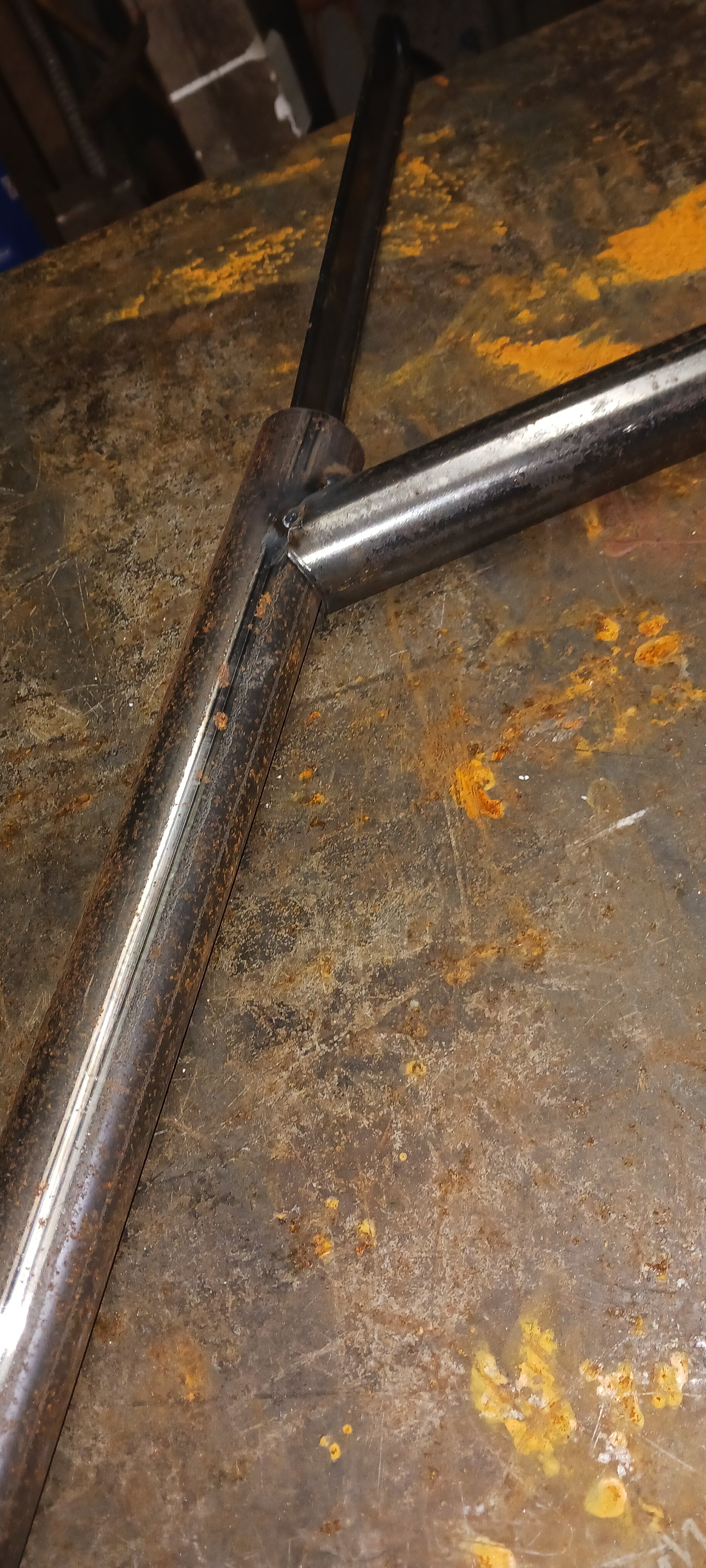 This slide shows the lower horizontal rail being fit up to one of the legs. Making the "fish-mouth" shape cope in the pipe is important. Its easier to get exact dimensions, it looks much nicer and its much easier to weld together.