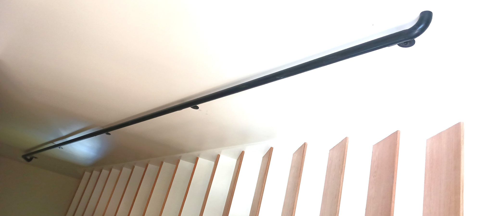 Here's one of the handrails after finish paint and installation.  Very dull lighting so I edited the brightness to show the top landing a little better.